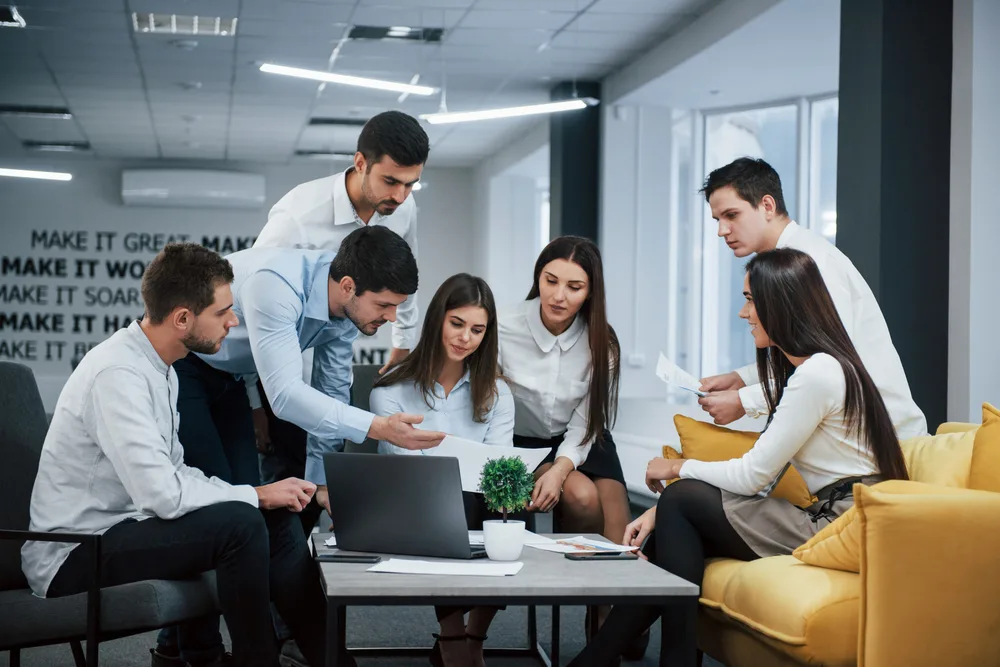 guy shows document girl group young freelancers office have conversation working